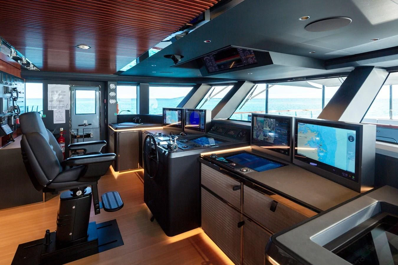 a room with computers and monitors aboard FIFTY Yacht for Charter