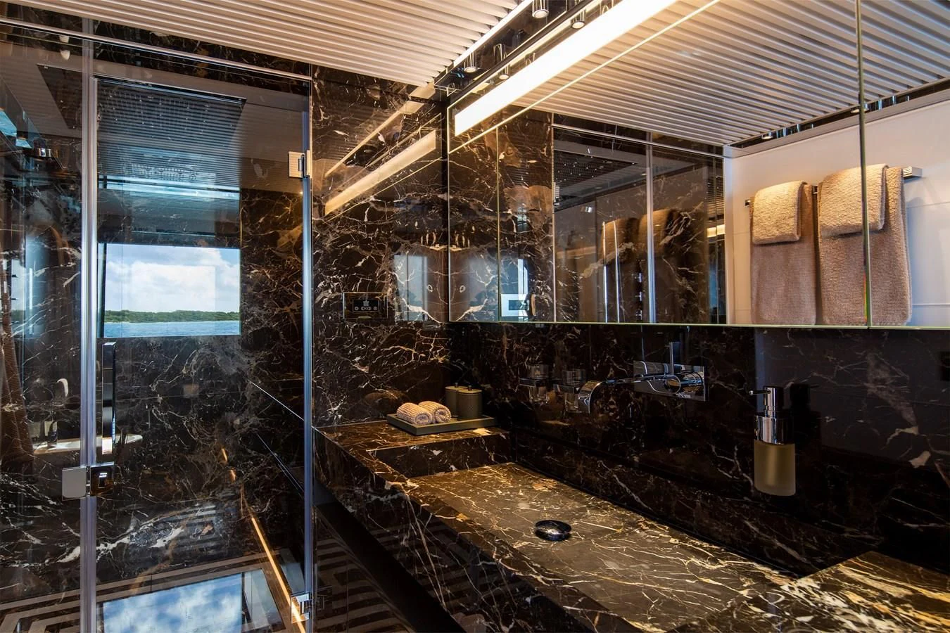 a bathroom with a large glass shower aboard FIFTY Yacht for Charter