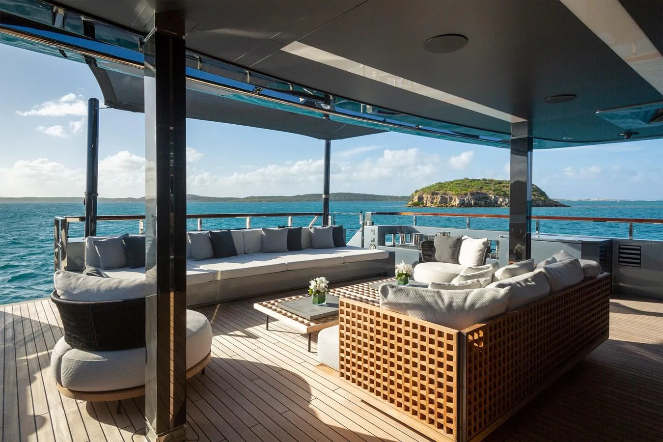 a room with a couch and a table and a view of the ocean aboard FIFTY Yacht for Charter