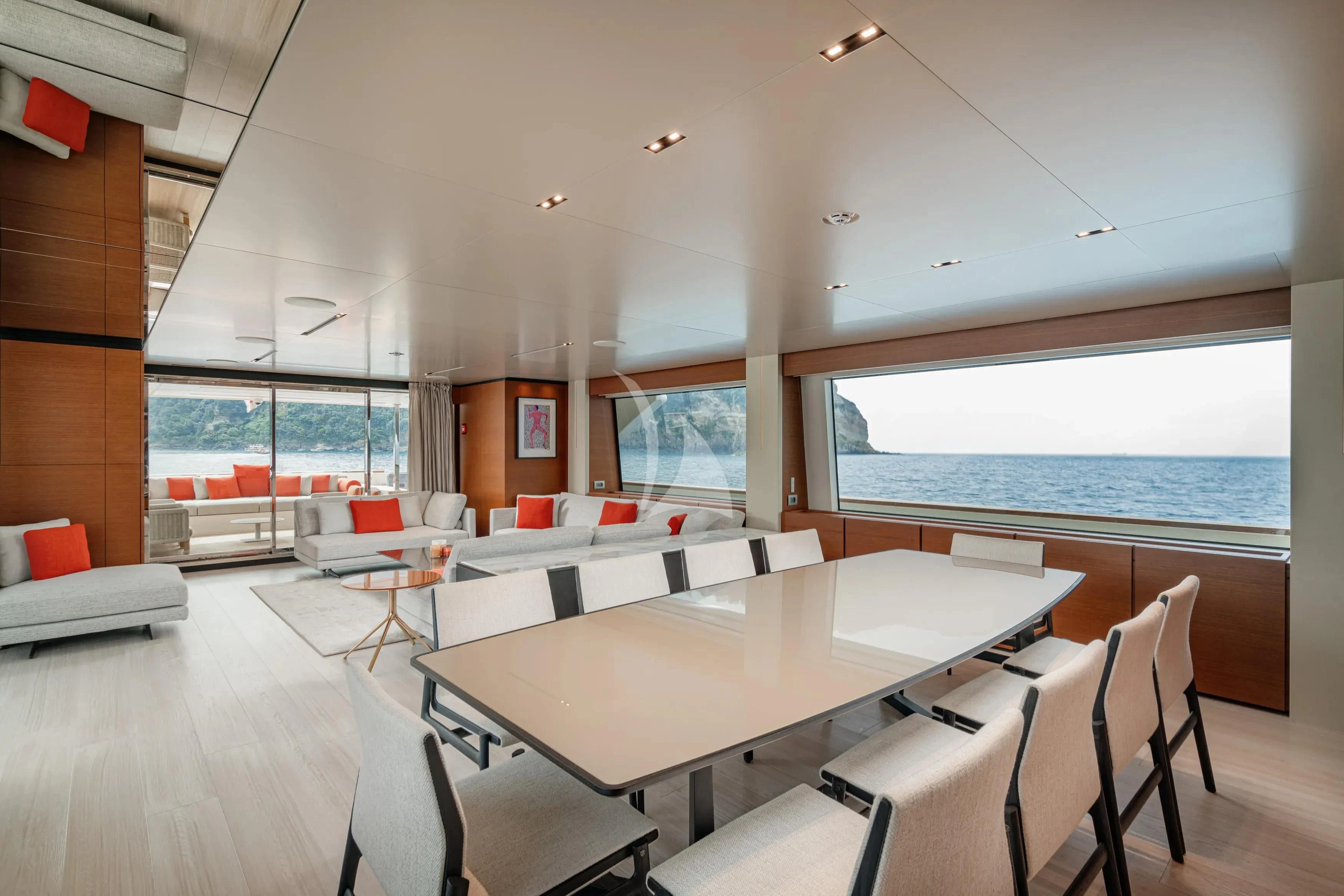 a room with a table chairs and a large window aboard DIANA II Yacht for Sale