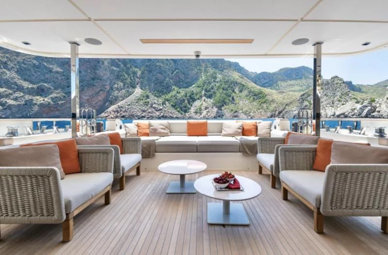 a large living room with a large body of water behind it aboard DIANA II Yacht for Sale