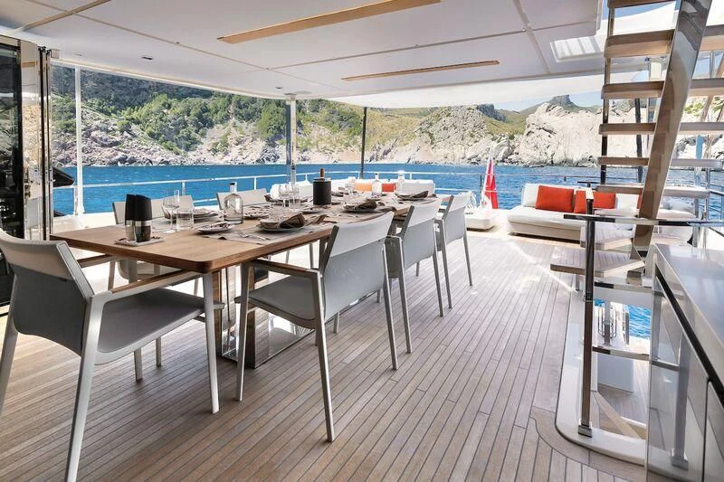 a dining table on a balcony aboard DIANA II Yacht for Sale