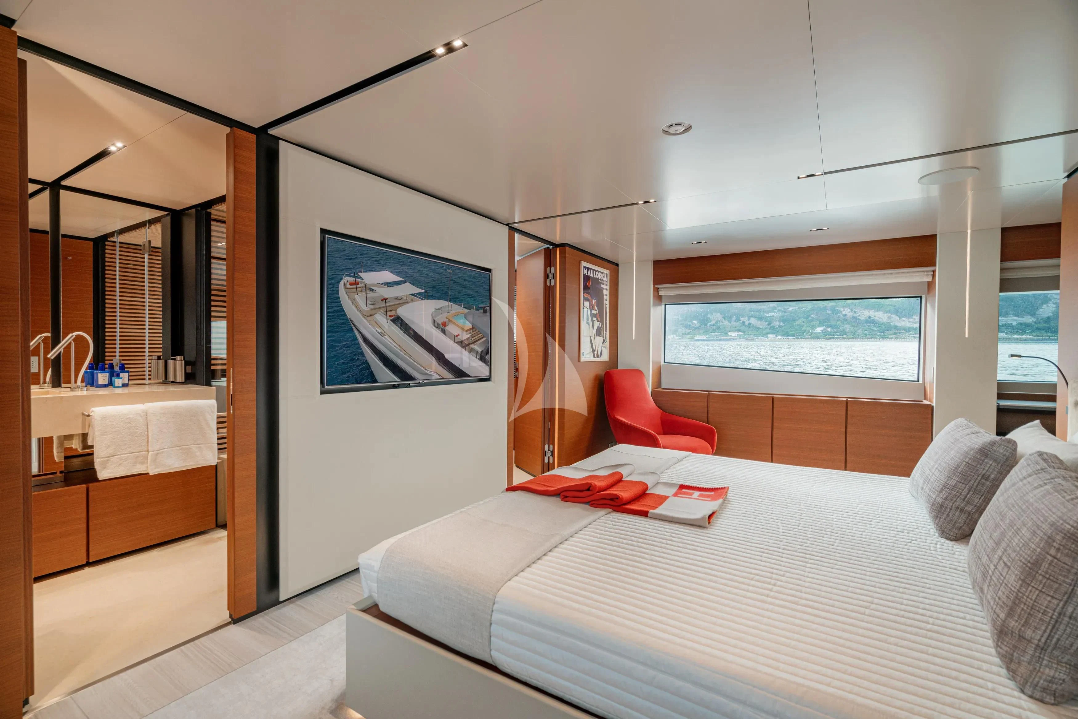 a bedroom with a bed and a chair aboard DIANA II Yacht for Sale
