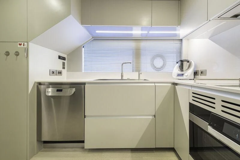 a kitchen with white cabinets aboard DIANA II Yacht for Sale