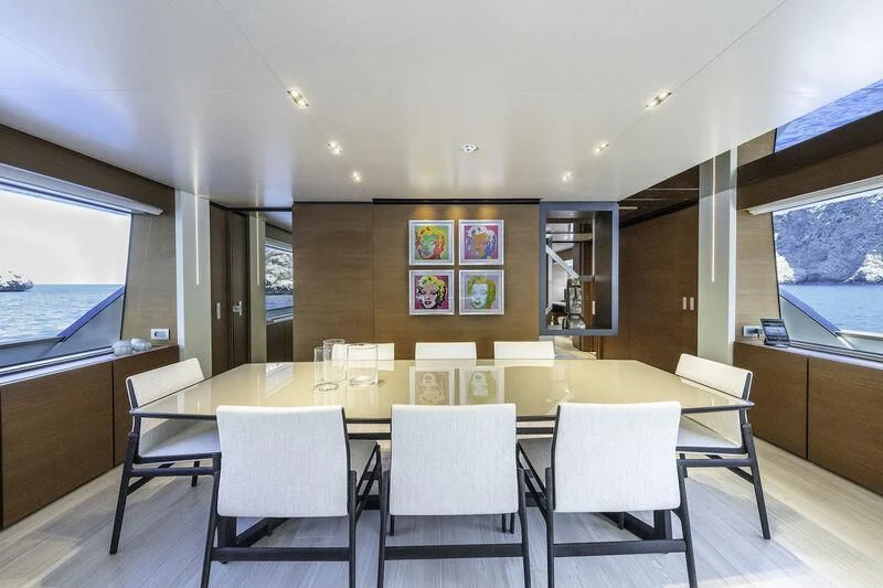 a room with tables and chairs aboard DIANA II Yacht for Sale