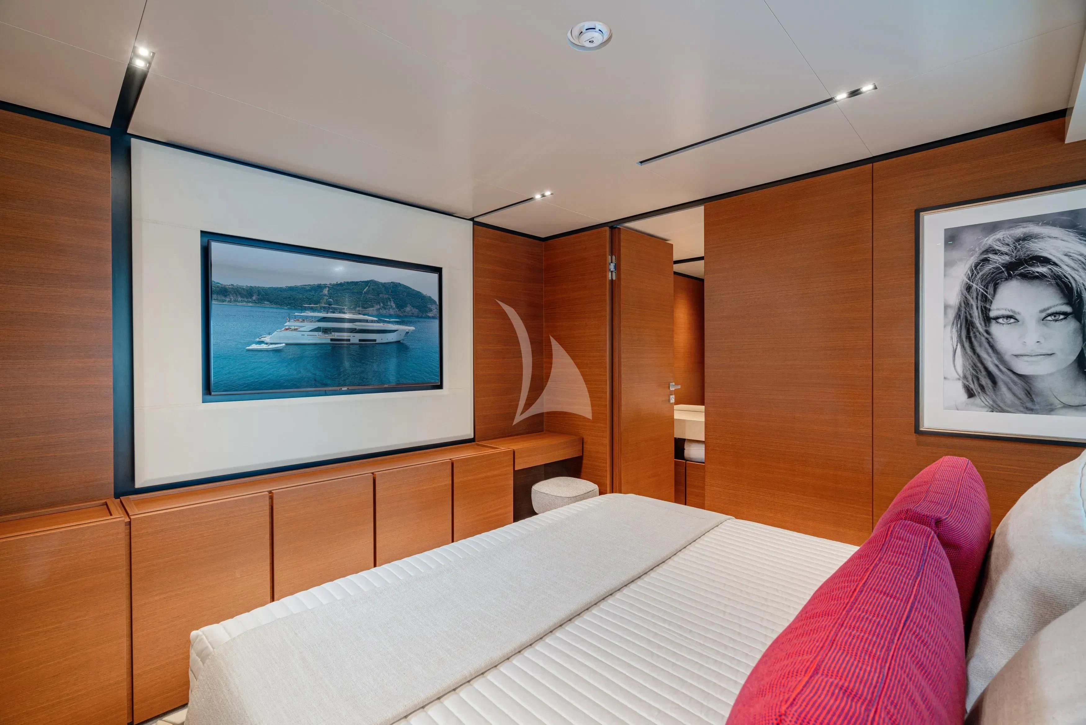 a room with a bed and a television on the wall aboard DIANA II Yacht for Sale
