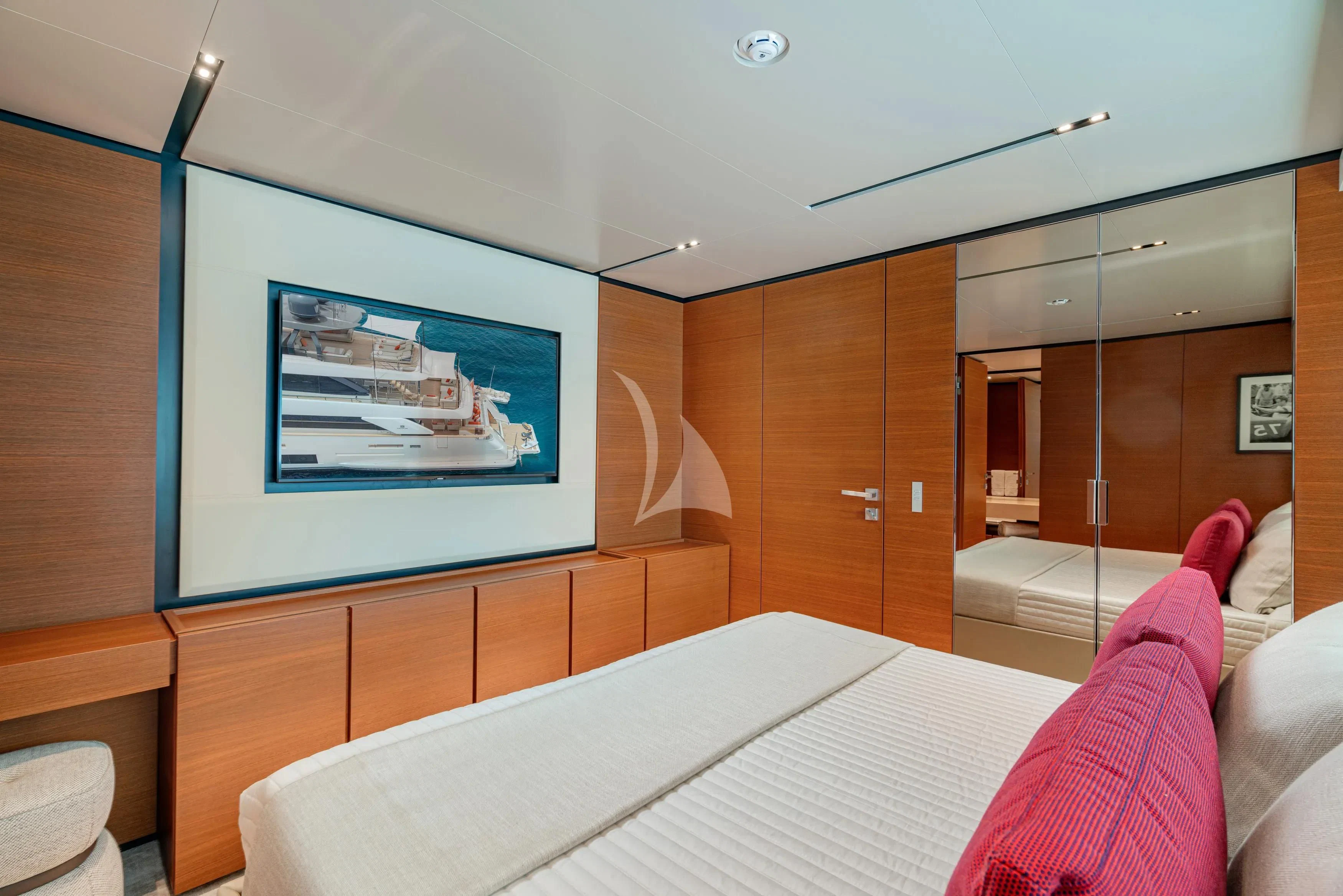 a room with a bed and a television on the wall aboard DIANA II Yacht for Sale