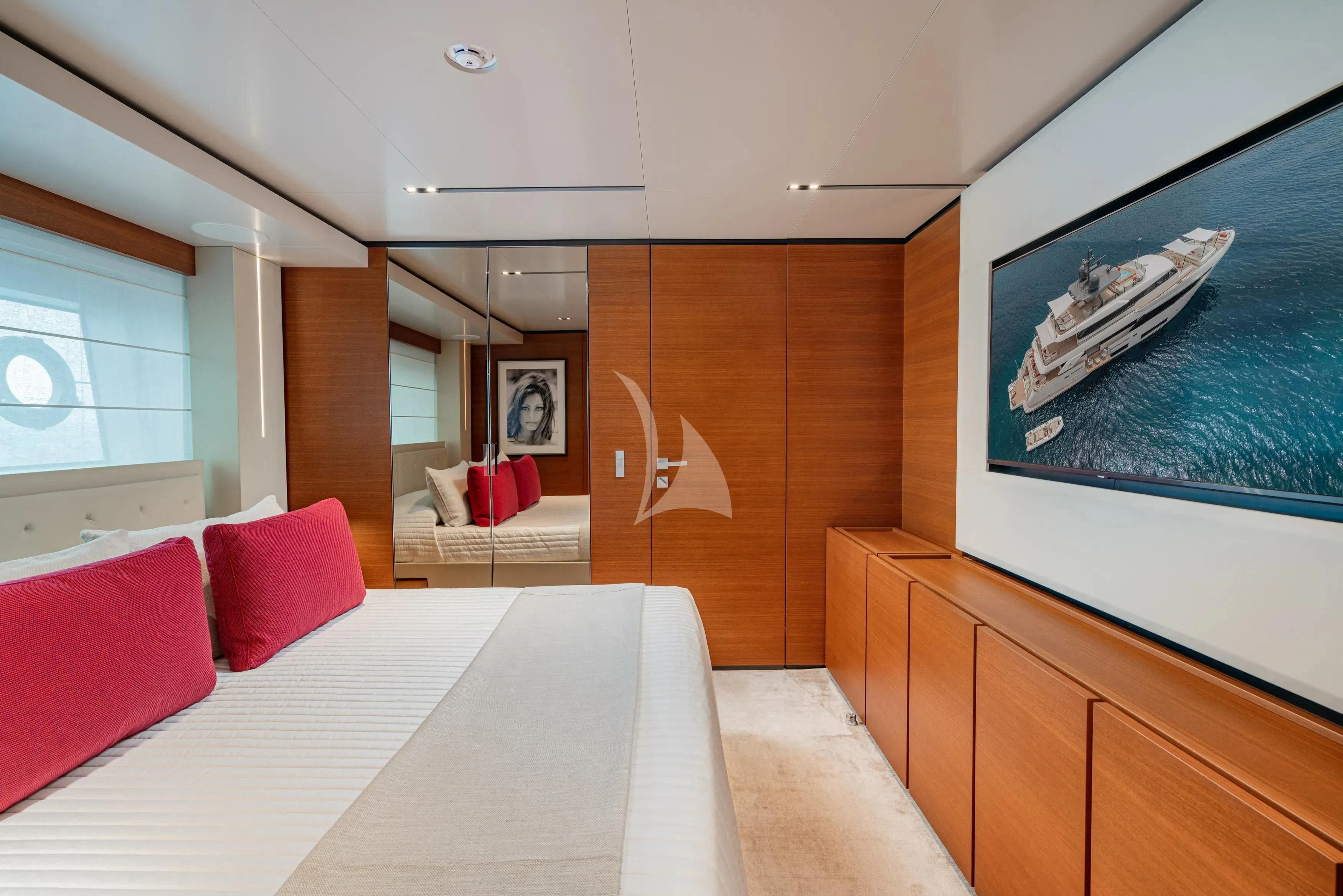 a room with a bed and a tv on the wall aboard DIANA II Yacht for Sale