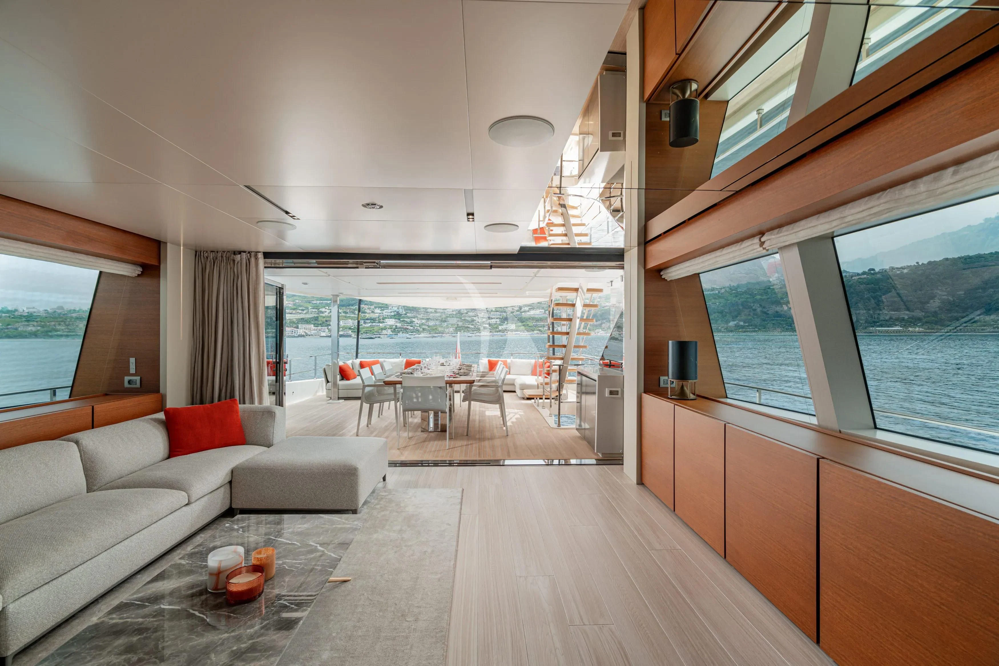 a living room with a large balcony aboard DIANA II Yacht for Sale