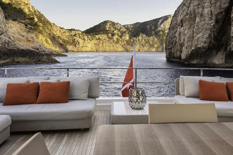 a deck with a sofa and a boat on it aboard DIANA II Yacht for Sale