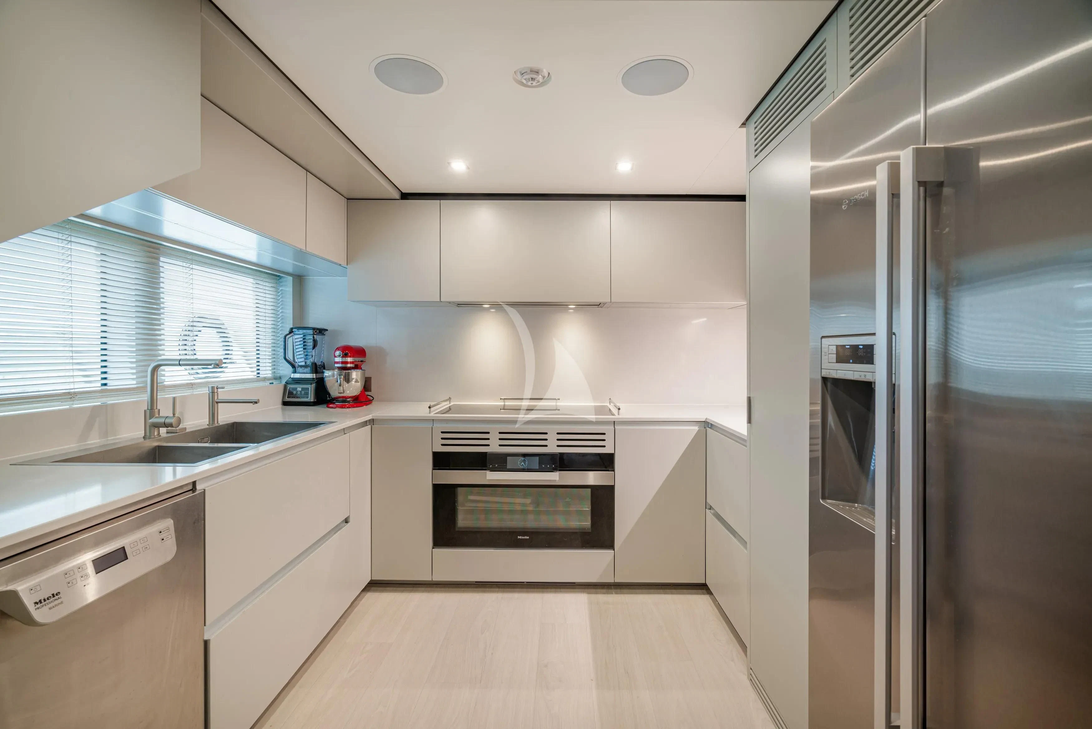 a kitchen with a refrigerator and sink aboard DIANA II Yacht for Sale