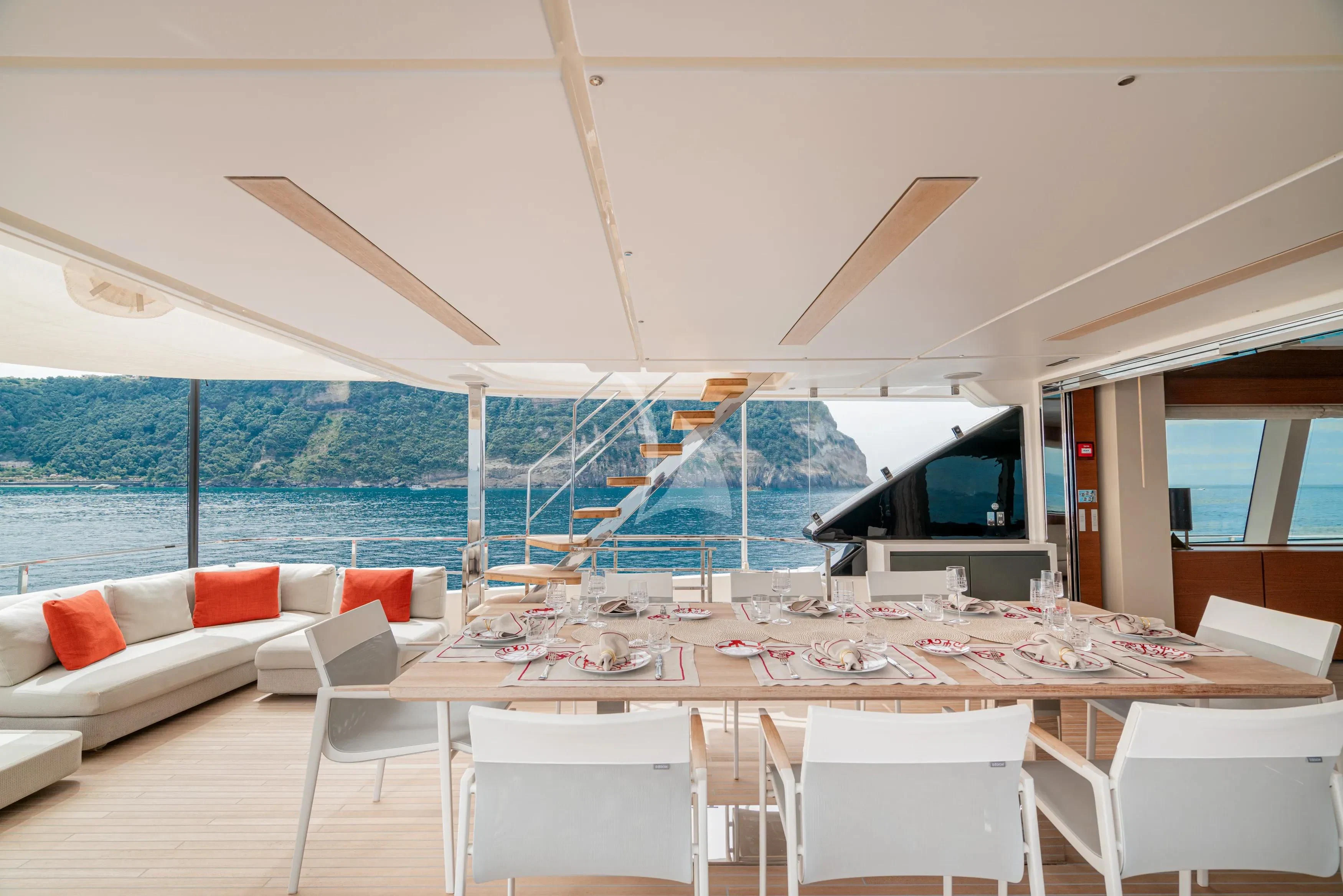 a room with a table and chairs aboard DIANA II Yacht for Sale