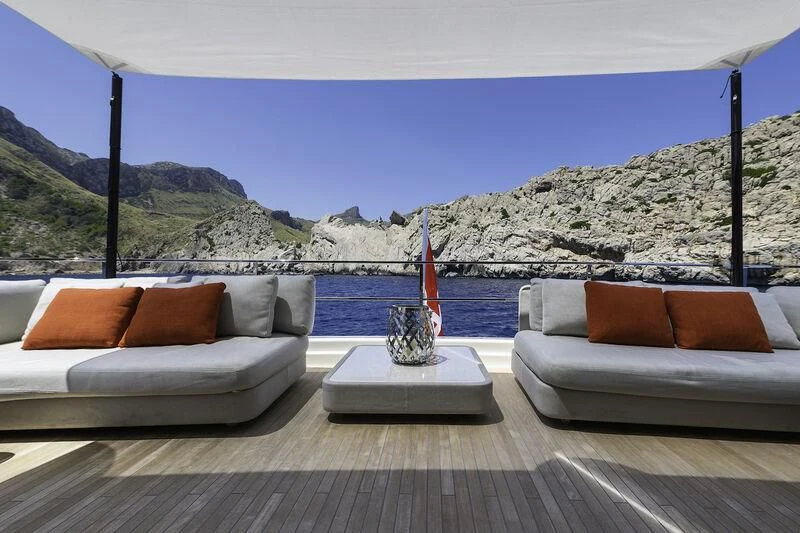 a living room with a large body of water and a large red object aboard DIANA II Yacht for Sale