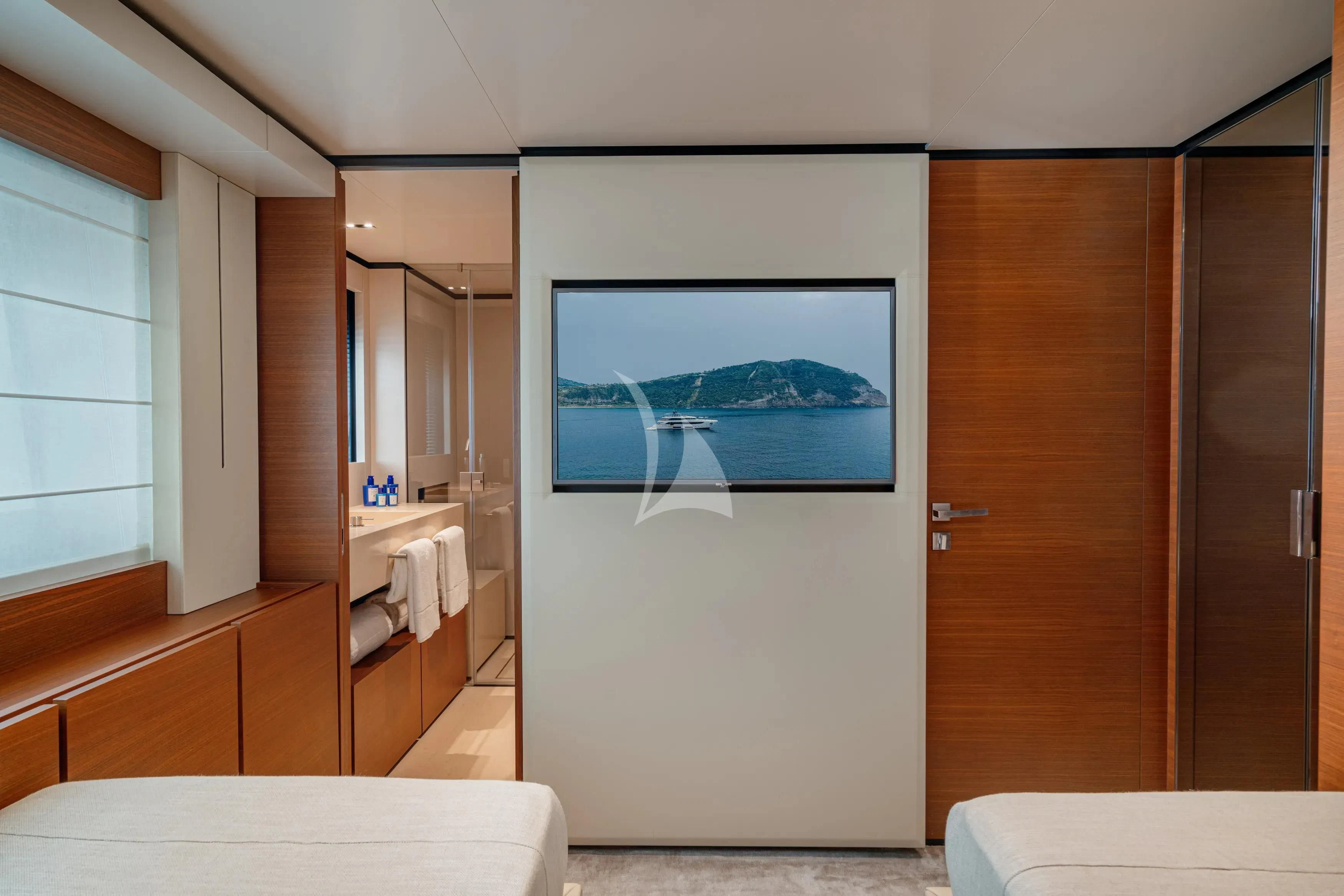 a room with a bed and a television aboard DIANA II Yacht for Sale