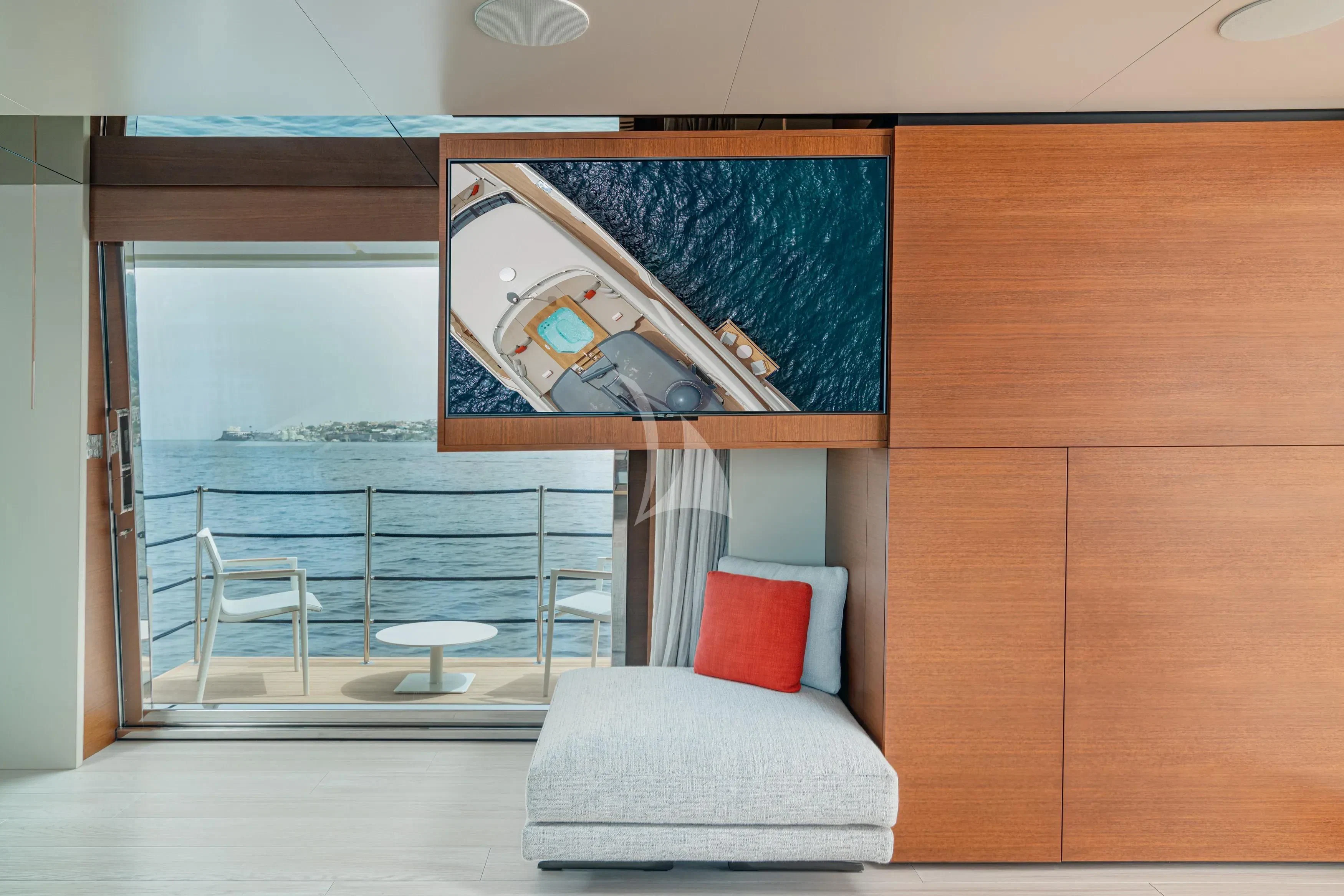 a room with a couch and a television on the wall aboard DIANA II Yacht for Sale