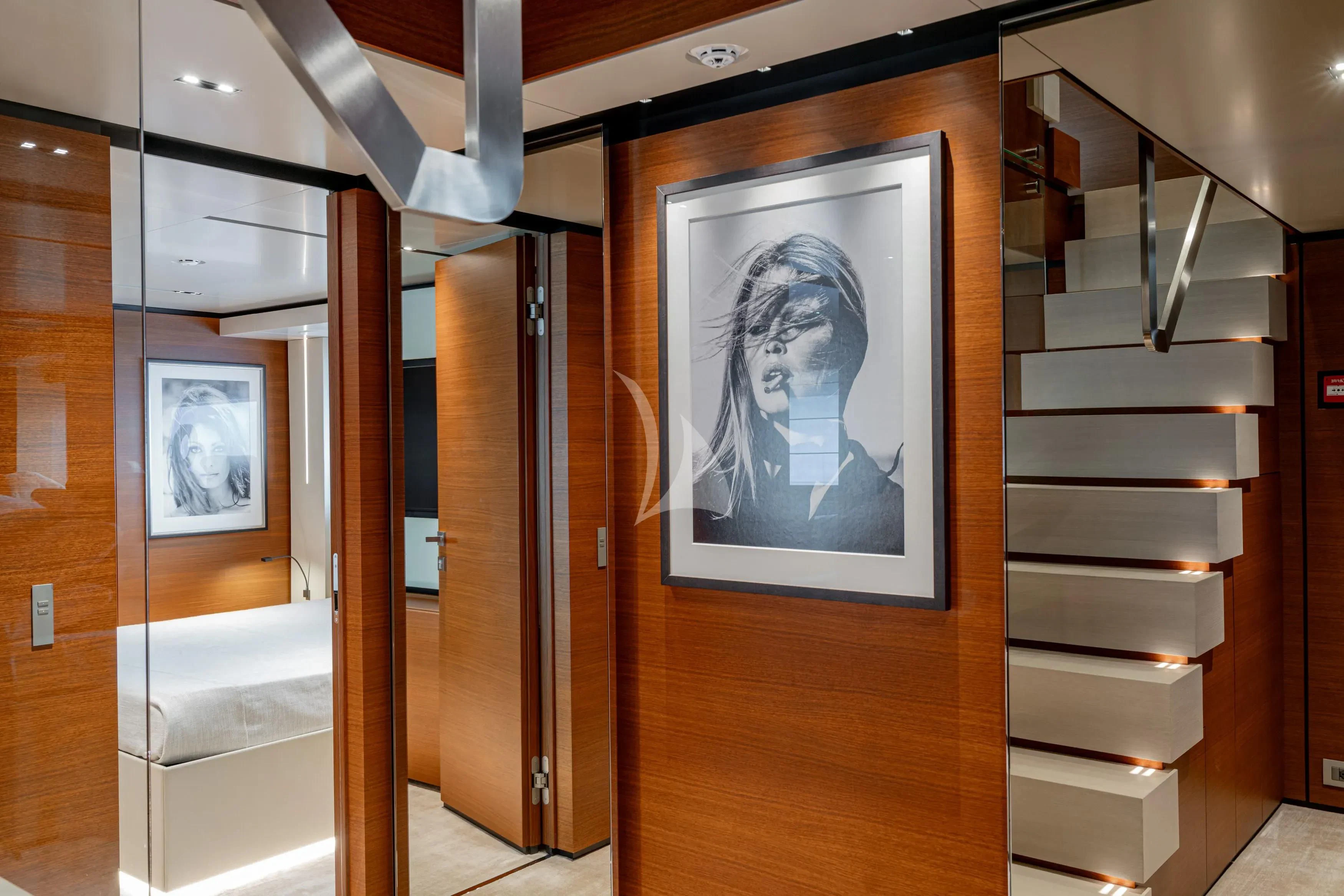 a room with a bookcase and a picture on the wall aboard DIANA II Yacht for Sale
