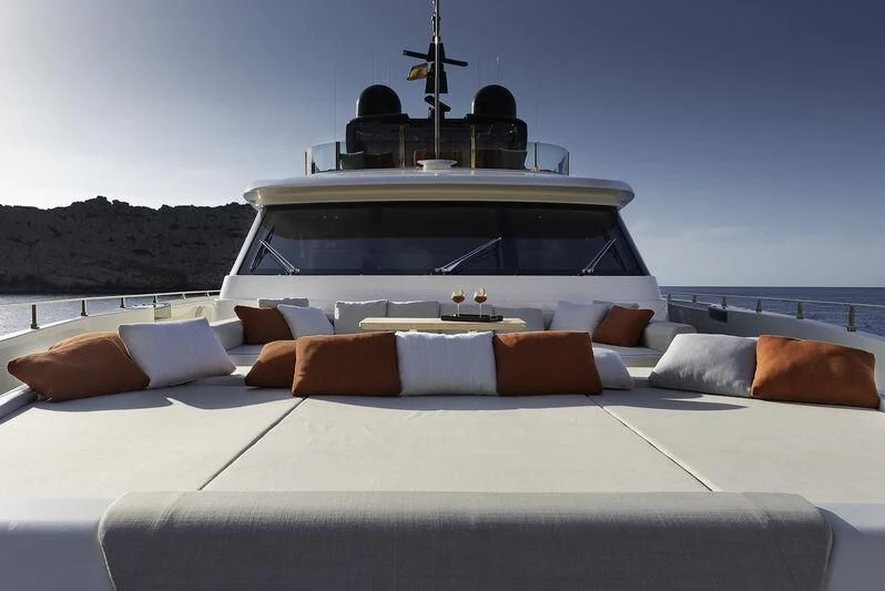 a white car with a white convertible roof and a white bed with a white and brown pillow on aboard DIANA II Yacht for Sale