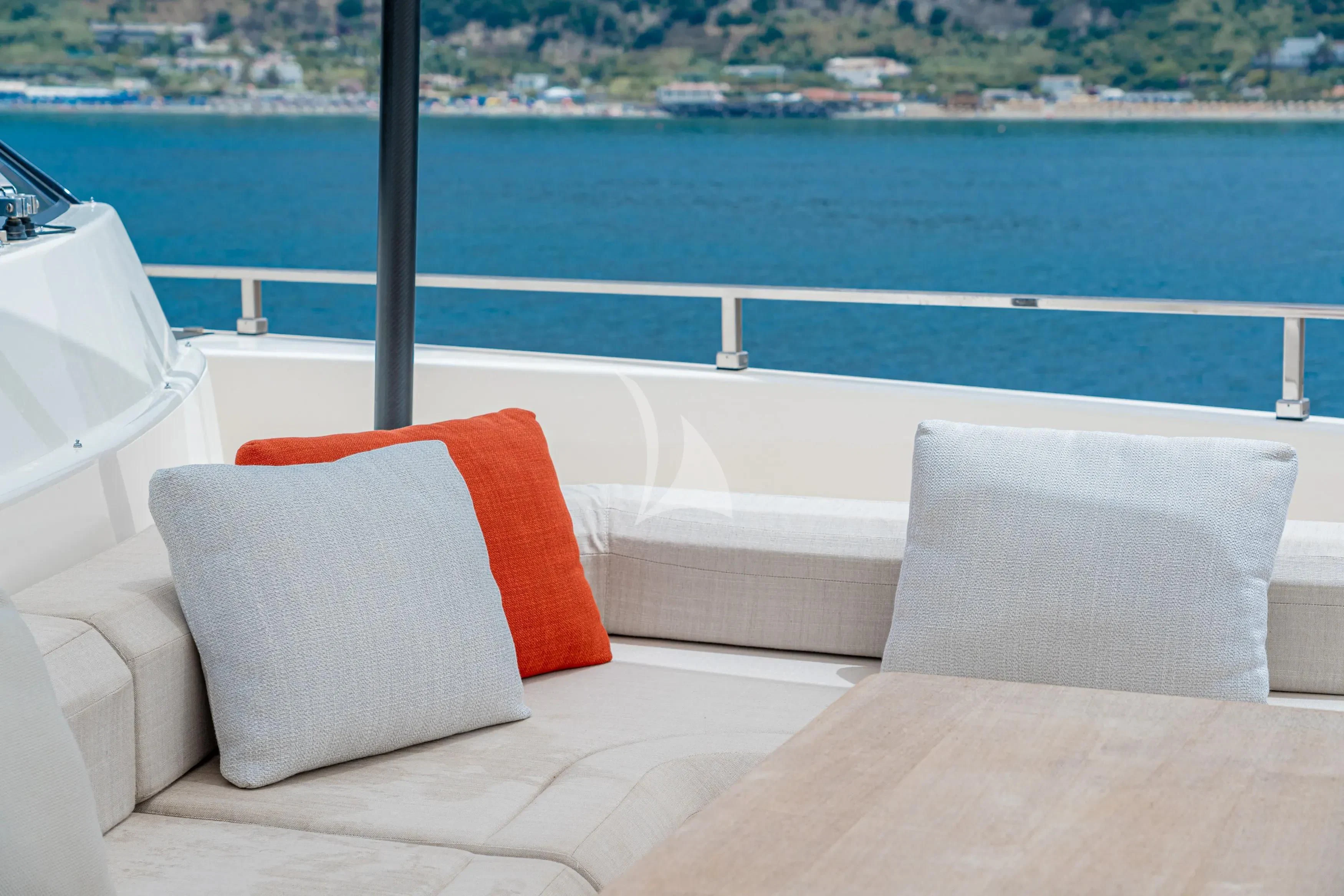 a couch on a balcony overlooking a body of water aboard DIANA II Yacht for Sale