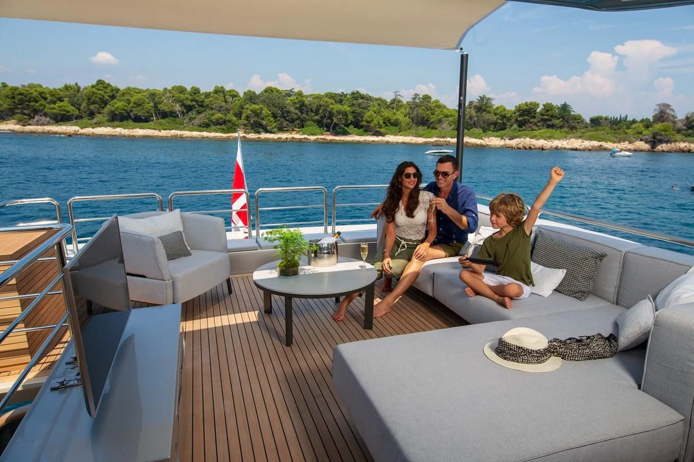 a group of people sitting on a boat on a dock aboard CANADOS 888 EVO Yacht for Sale