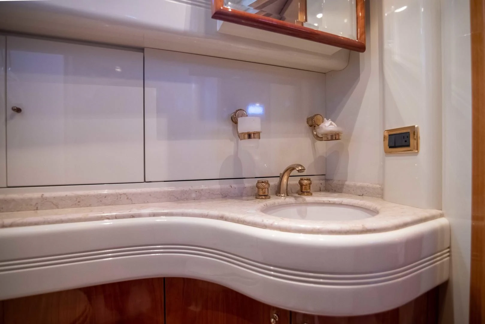 a bathroom with a sink and a mirror aboard ENCHANTED LADY Yacht for Sale