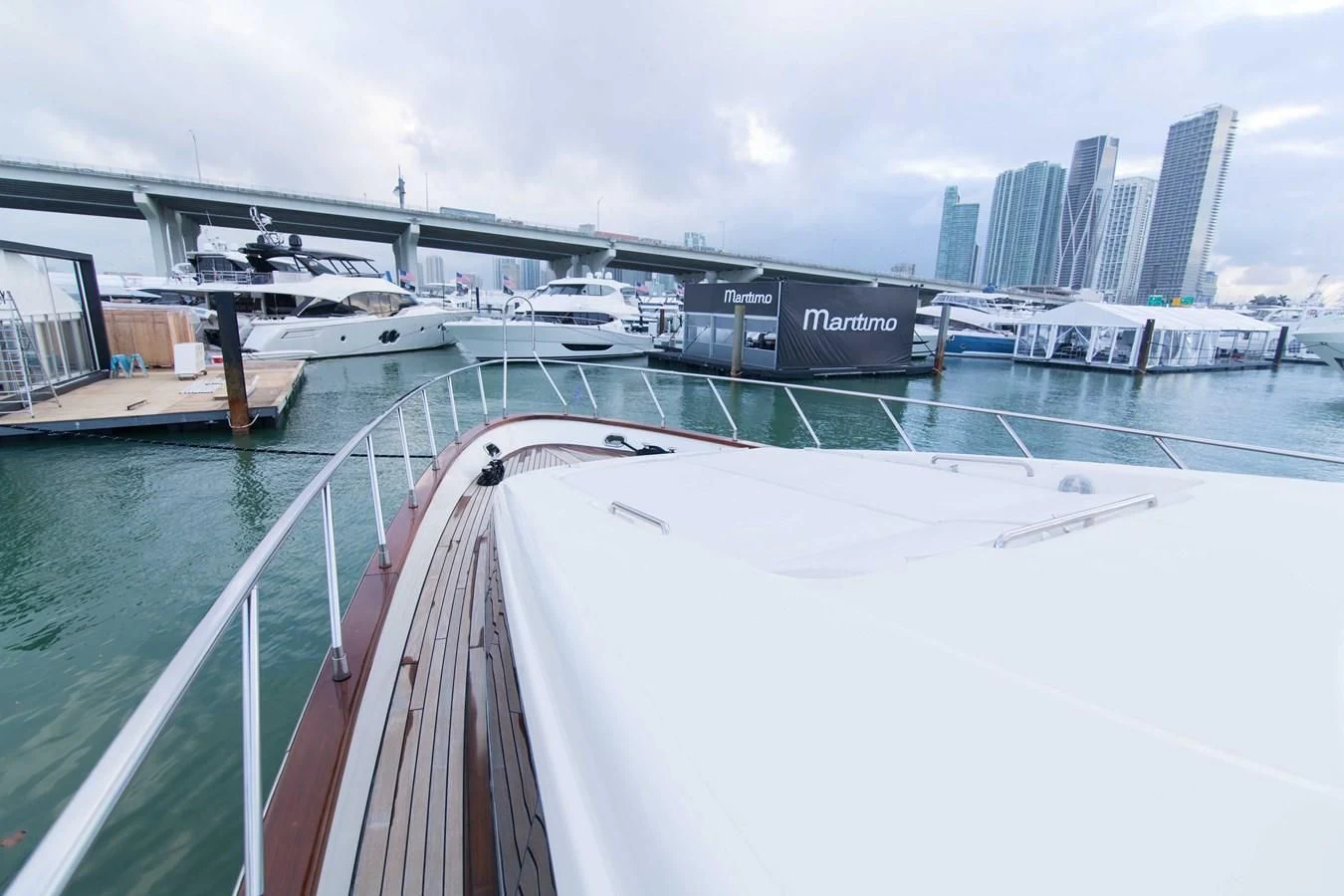 a large white boat in a harbor aboard ENCHANTED LADY Yacht for Sale