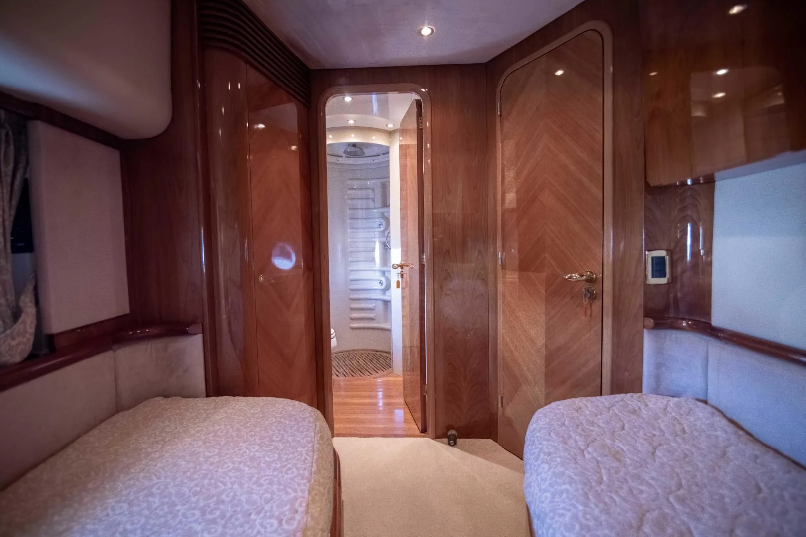 a room with a bed and a door aboard ENCHANTED LADY Yacht for Sale