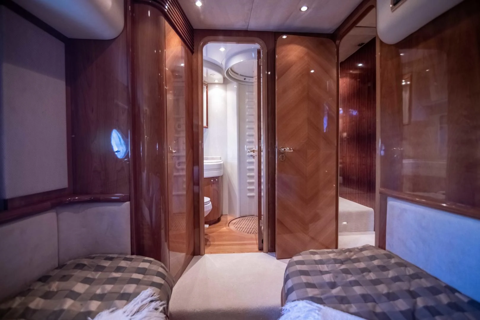 a room with a bed and a mirror aboard ENCHANTED LADY Yacht for Sale