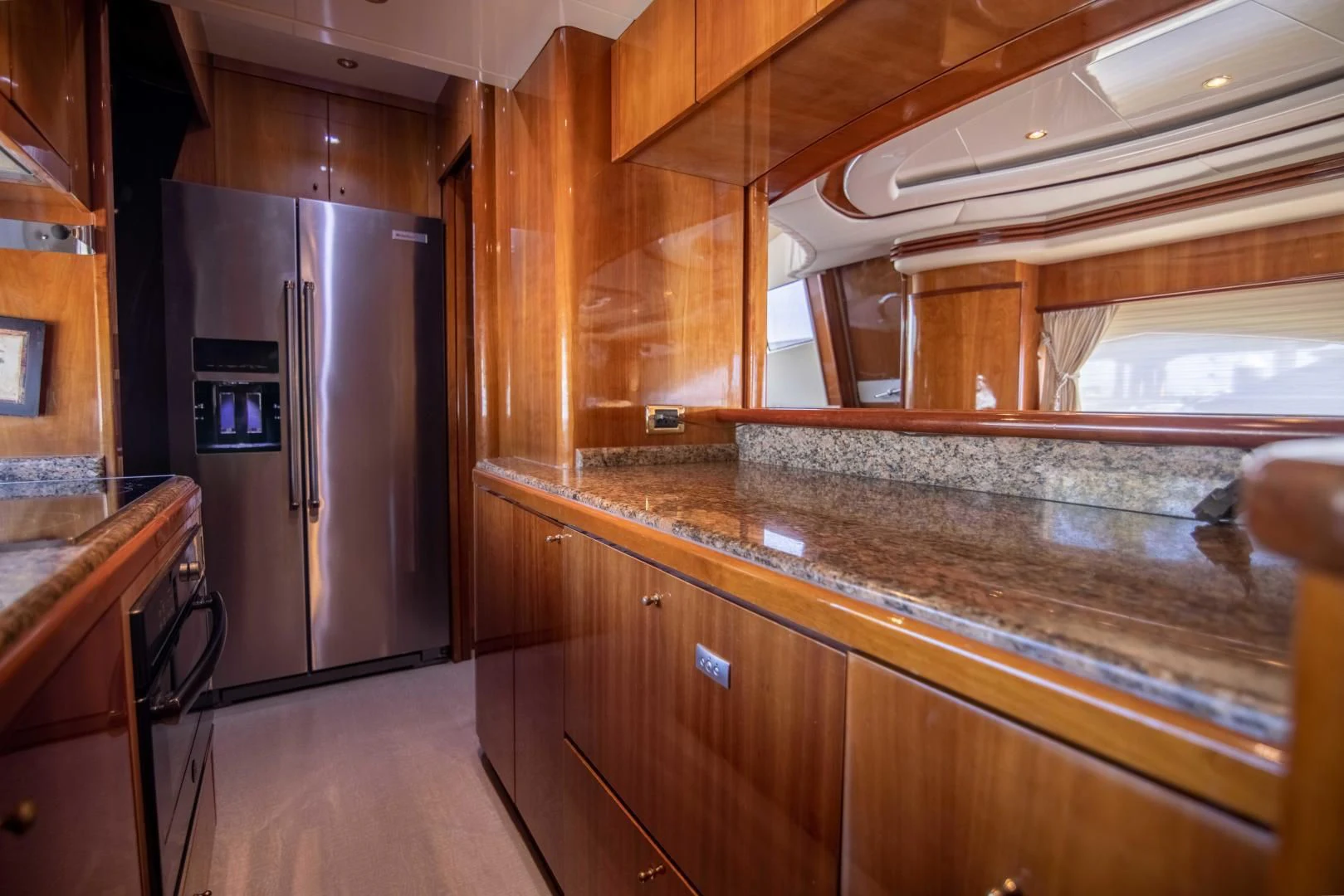 a kitchen with a stainless steel refrigerator aboard ENCHANTED LADY Yacht for Sale