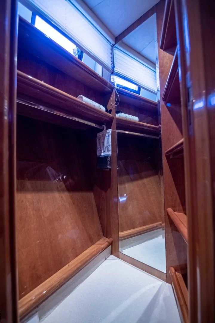 a room with a wood door and a window with blinds aboard ENCHANTED LADY Yacht for Sale