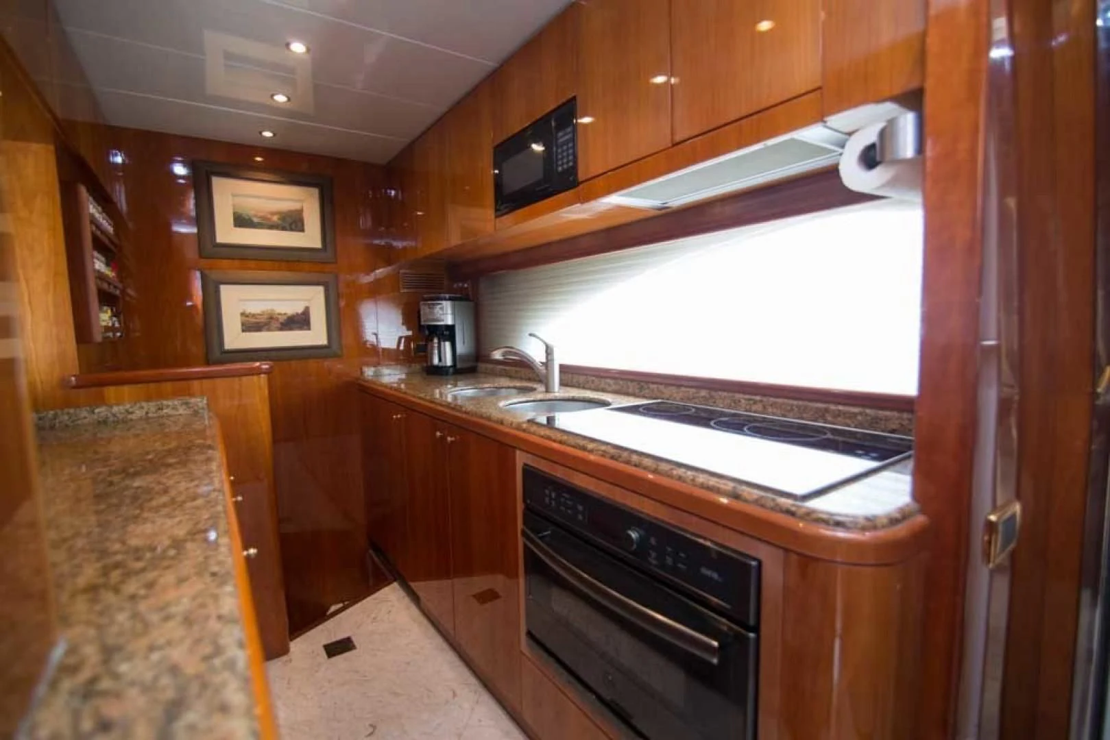 a kitchen with wooden cabinets aboard ENCHANTED LADY Yacht for Sale