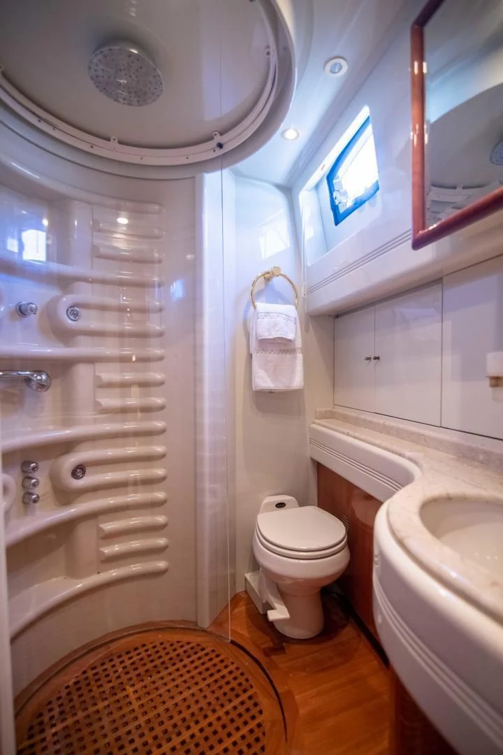 a bathroom with a toilet and sink aboard ENCHANTED LADY Yacht for Sale