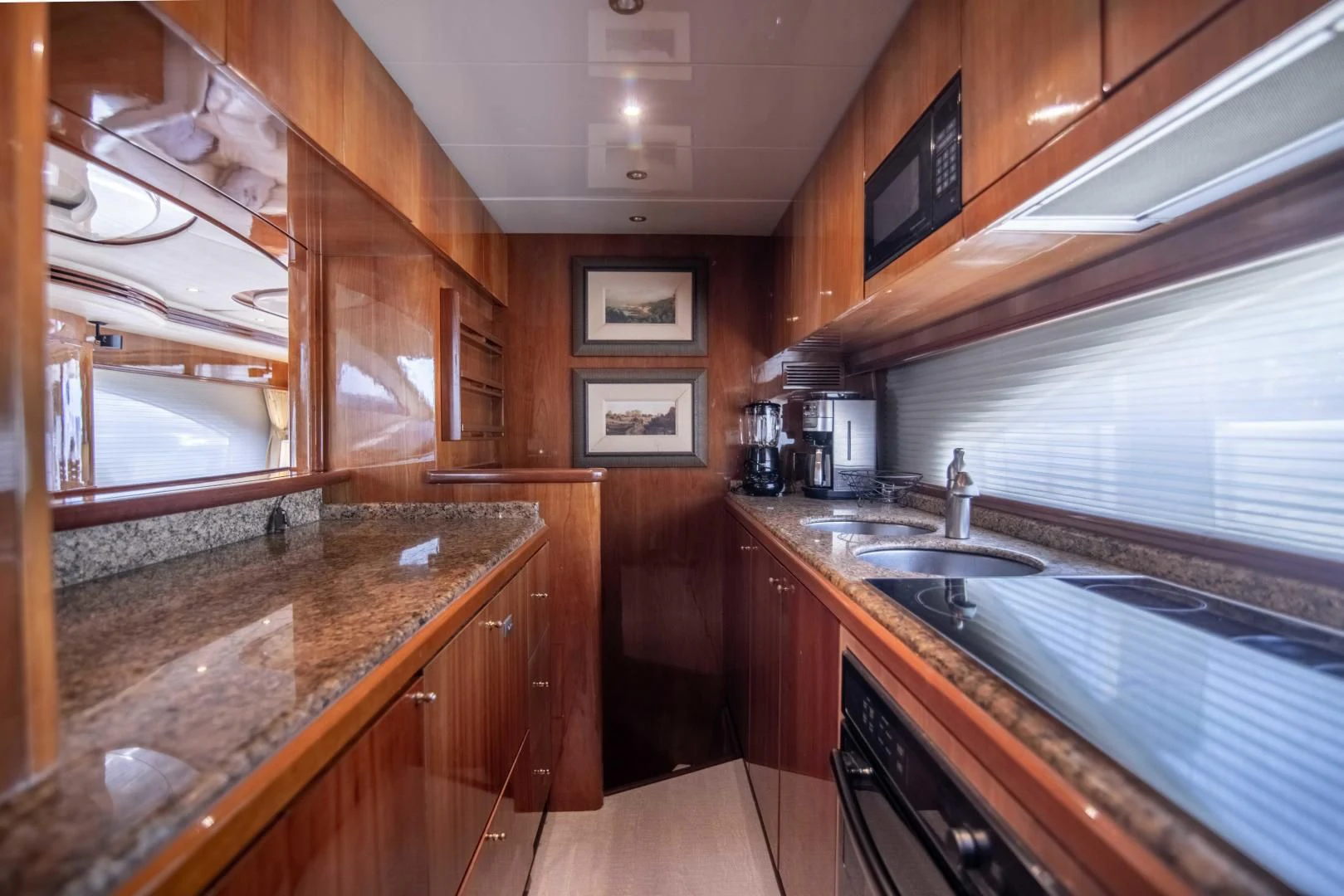 a kitchen with wooden cabinets aboard ENCHANTED LADY Yacht for Sale