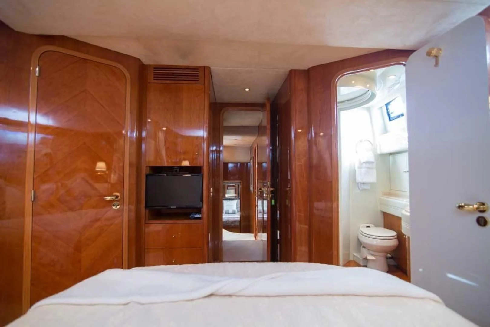 a bedroom with a bed and a television aboard ENCHANTED LADY Yacht for Sale