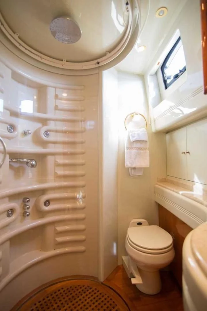 a bathroom with a toilet and a shower unit aboard ENCHANTED LADY Yacht for Sale