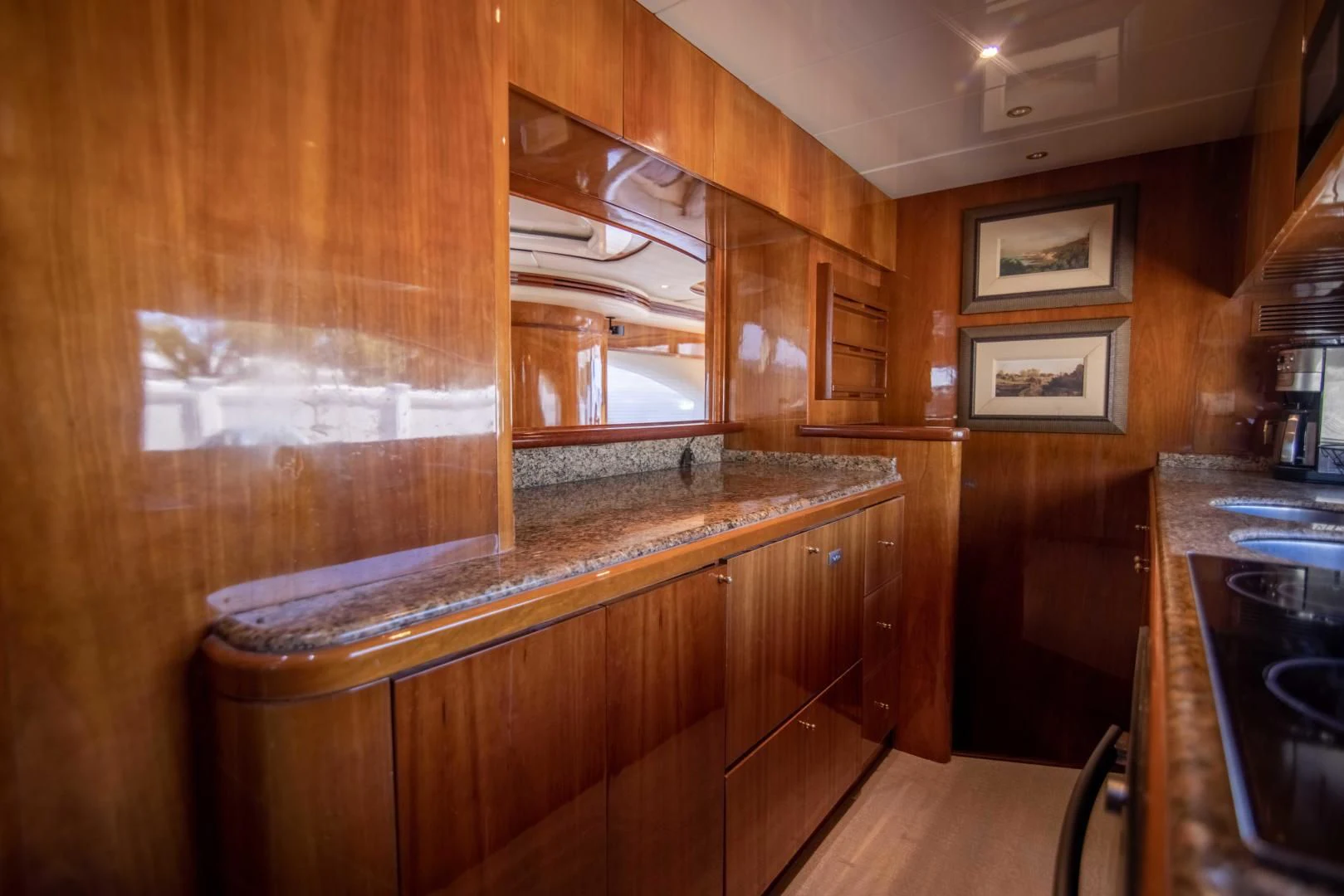 a kitchen with wooden cabinets aboard ENCHANTED LADY Yacht for Sale