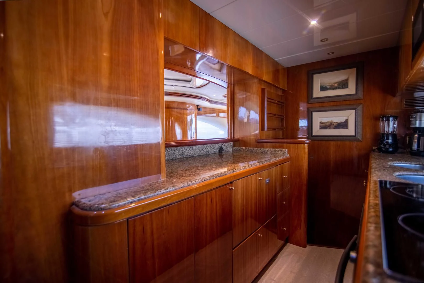 a kitchen with wooden cabinets aboard ENCHANTED LADY Yacht for Sale