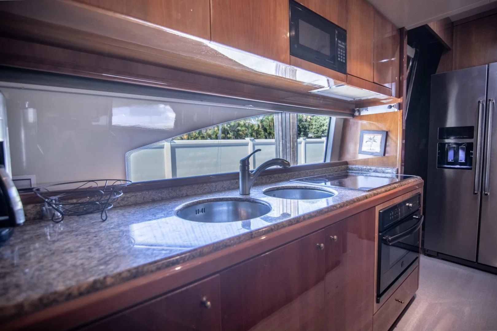 a kitchen with a sink and a window aboard ENCHANTED LADY Yacht for Sale