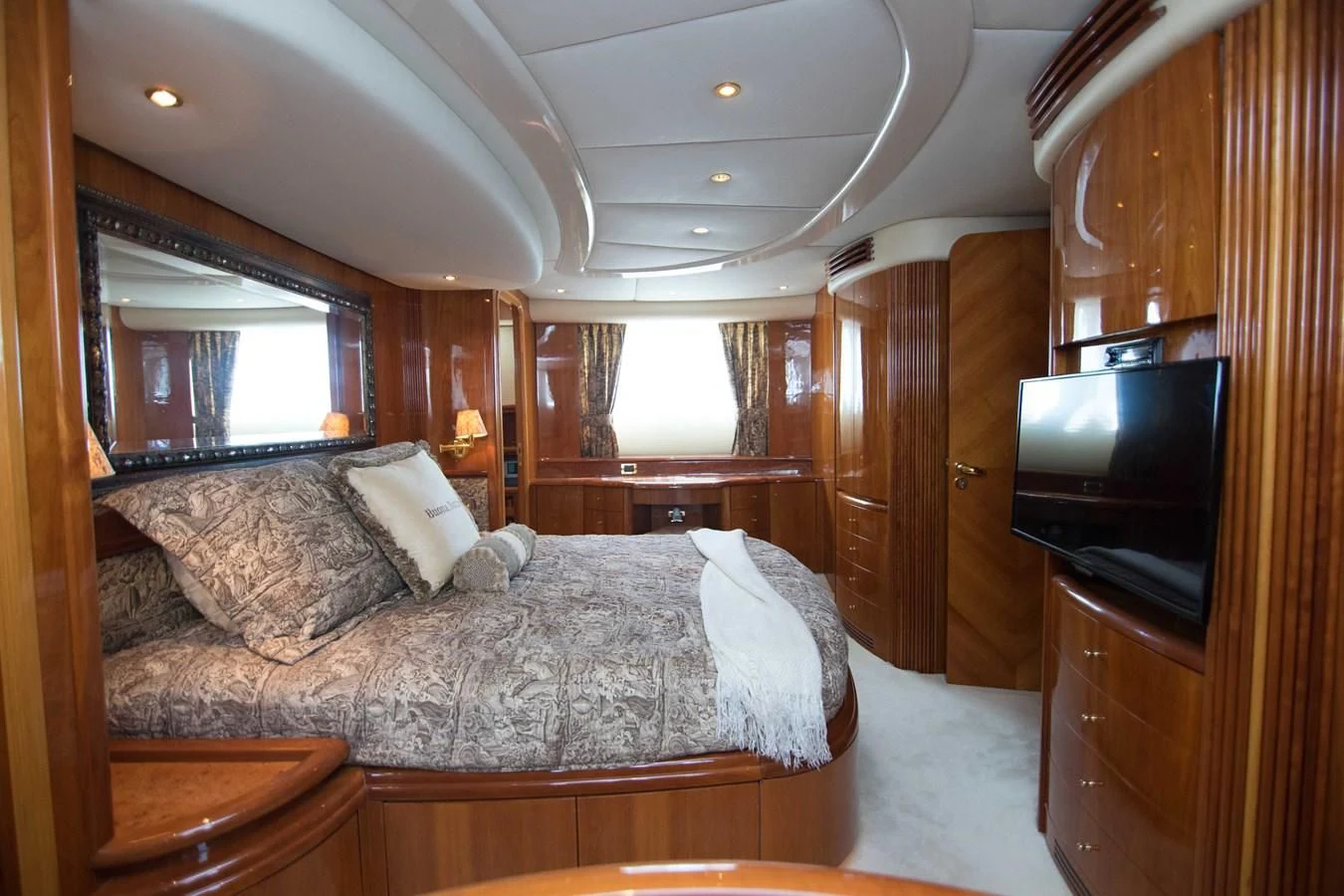 a bedroom with a bed and tv aboard ENCHANTED LADY Yacht for Sale