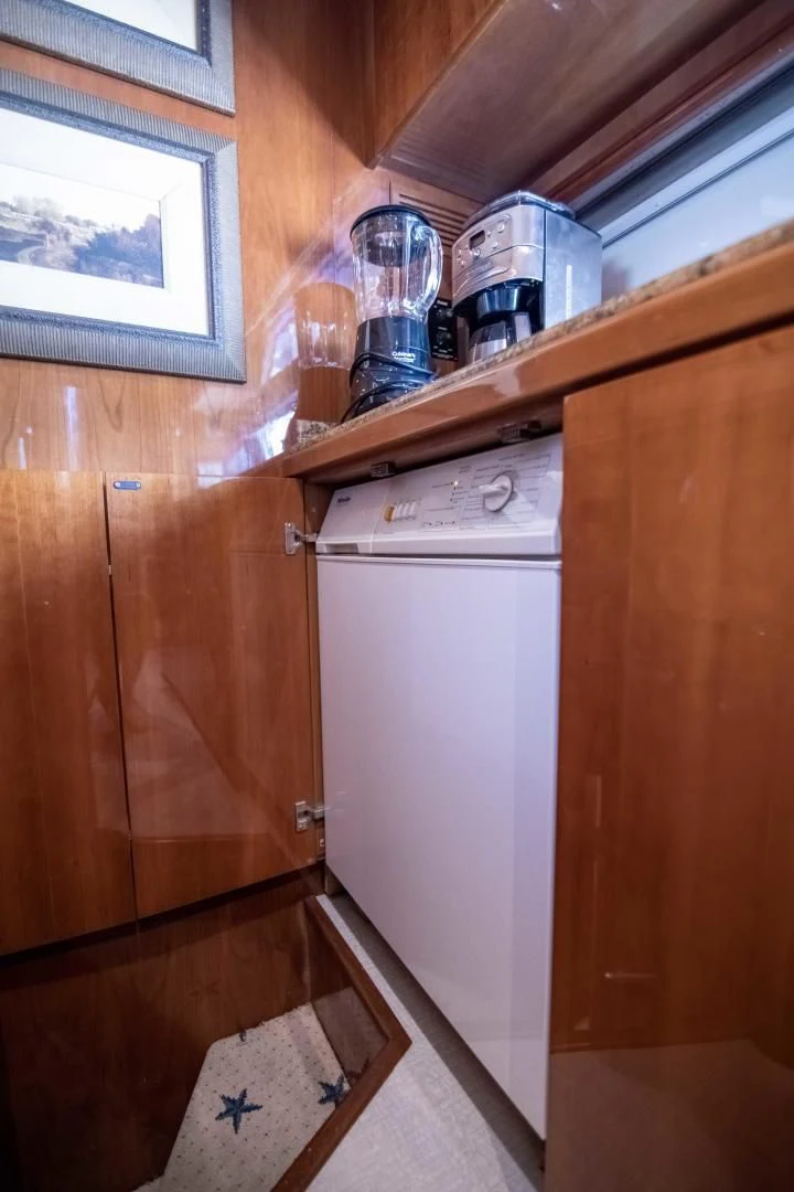 a small kitchen with wooden cabinets aboard ENCHANTED LADY Yacht for Sale