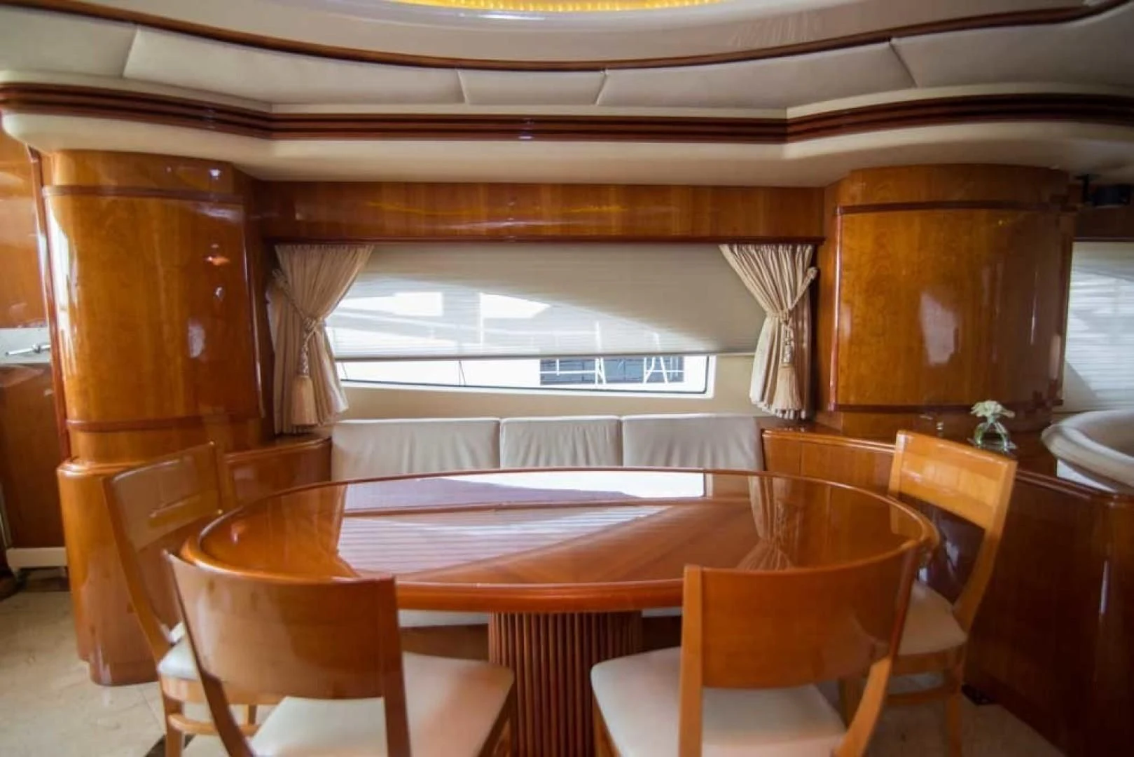 a room with tables and chairs aboard ENCHANTED LADY Yacht for Sale