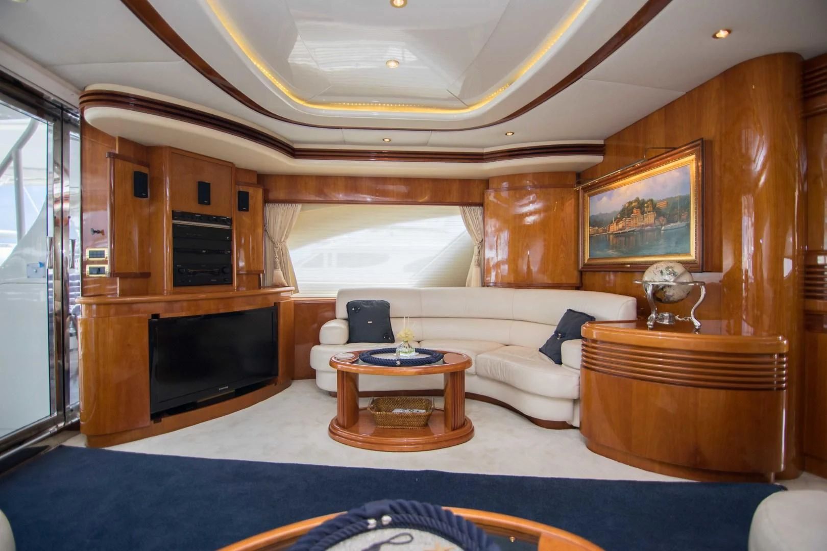 a living room with a blue rug aboard ENCHANTED LADY Yacht for Sale