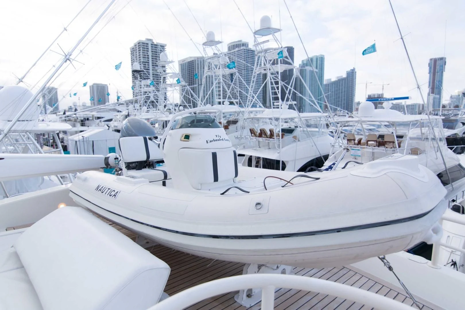 a white yacht in a harbor aboard ENCHANTED LADY Yacht for Sale