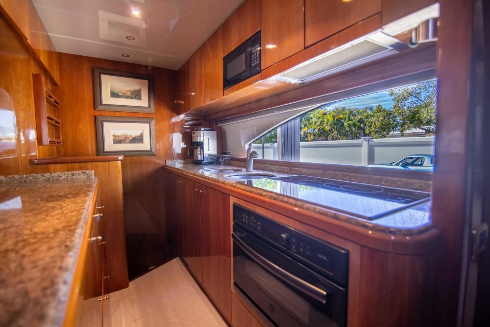 a kitchen with wooden cabinets aboard ENCHANTED LADY Yacht for Sale