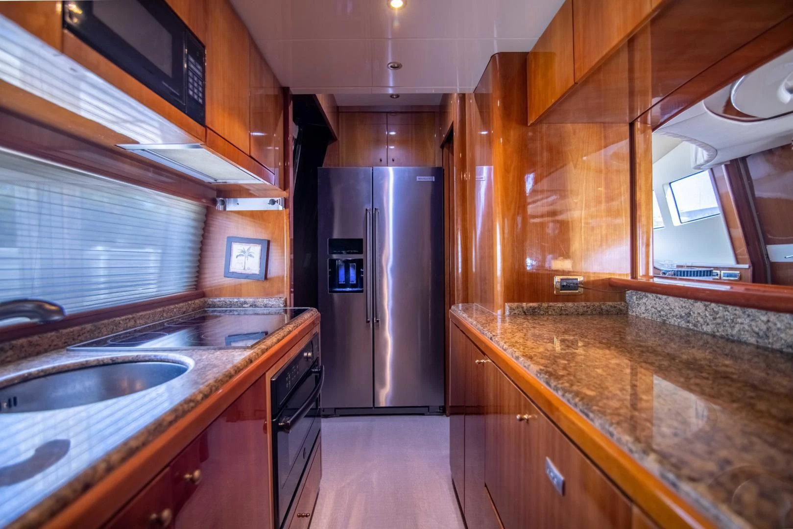 a kitchen with wooden cabinets aboard ENCHANTED LADY Yacht for Sale