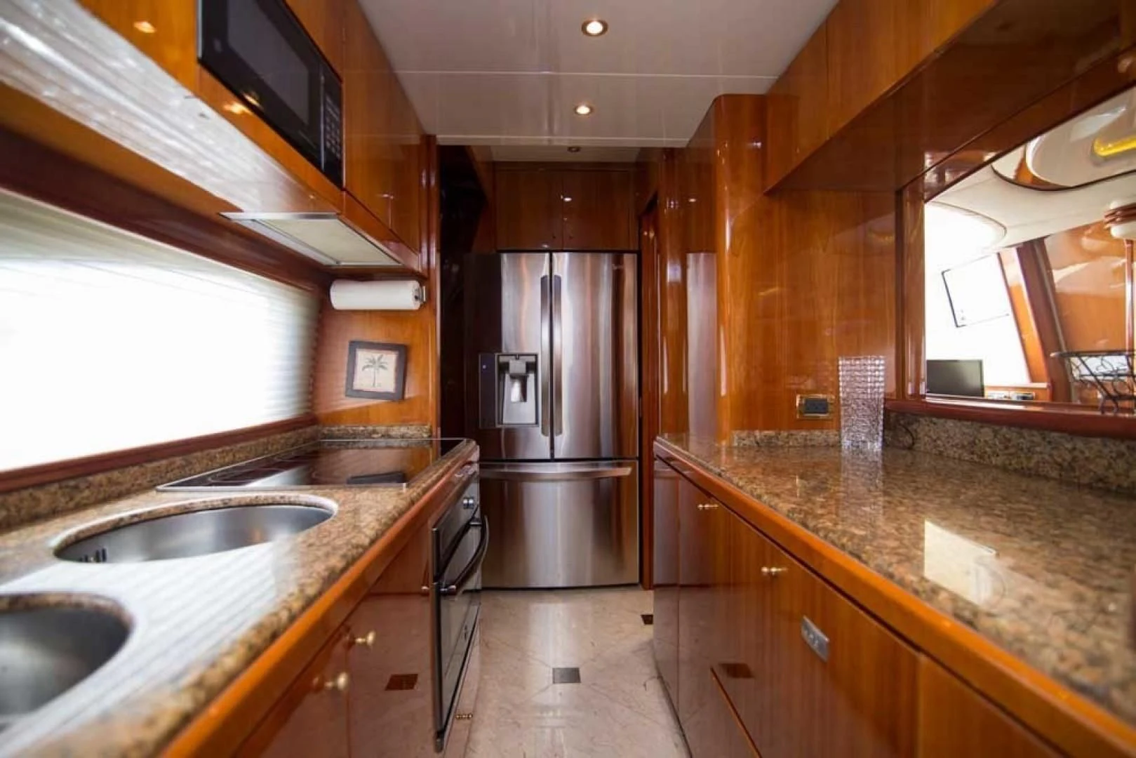 a kitchen with a stainless steel refrigerator aboard ENCHANTED LADY Yacht for Sale