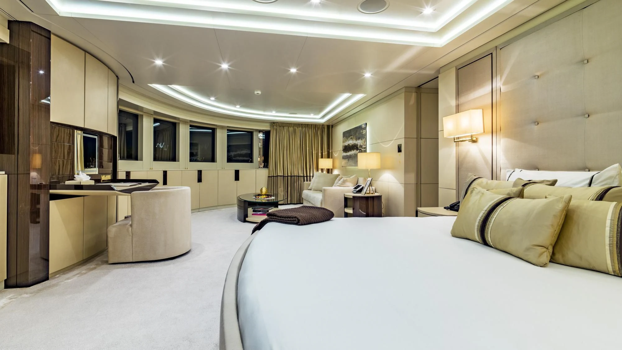 a hotel room with a bed and desk aboard ROMA Yacht for Sale