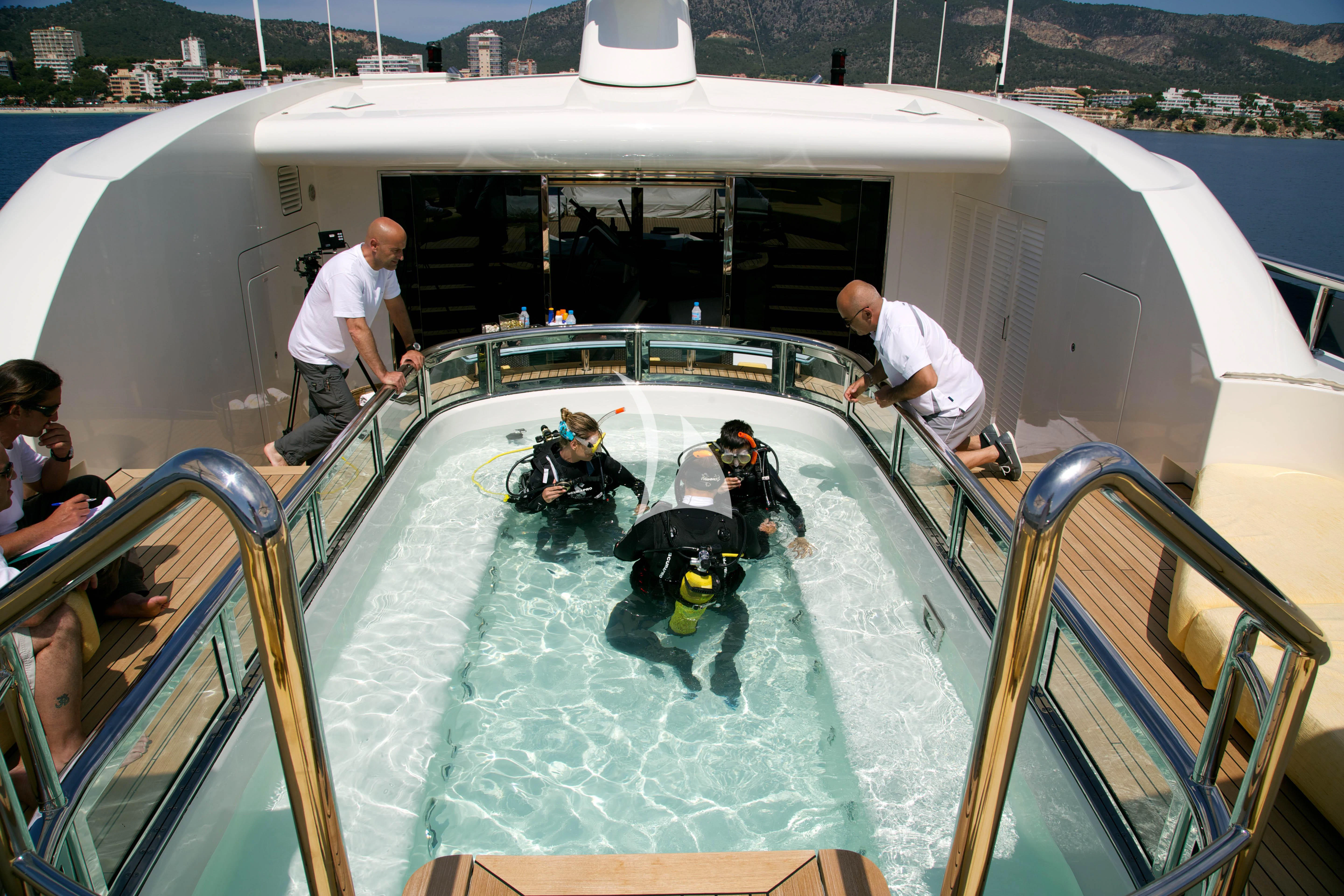 a group of people in a pool aboard ROMA Yacht for Sale