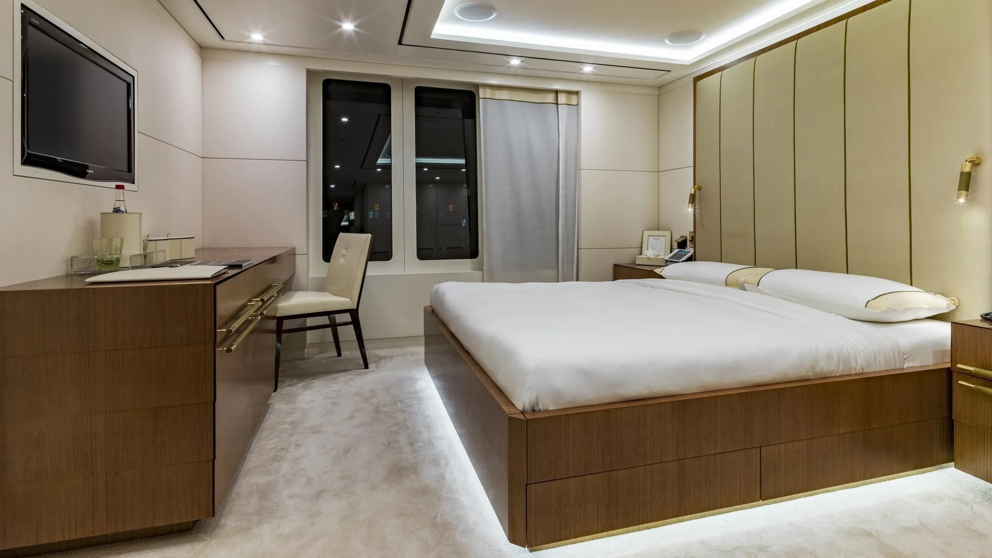 a hotel room with a bed and tv aboard ROMA Yacht for Sale