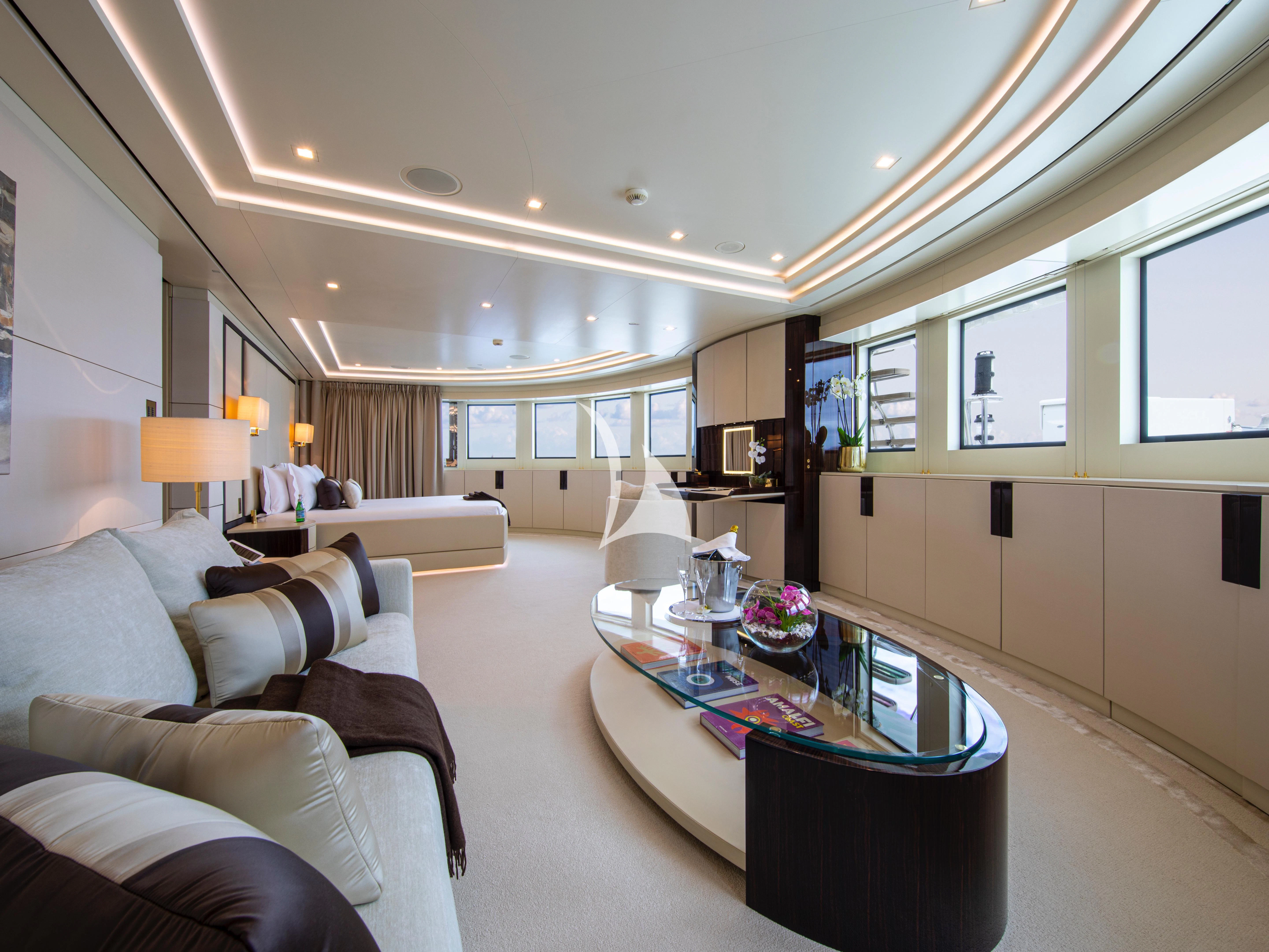 a living room with a couch and a coffee table aboard ROMA Yacht for Sale
