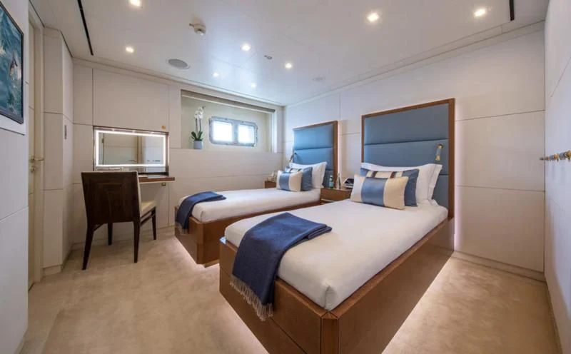 a room with a bed and a chair aboard ROMA Yacht for Sale